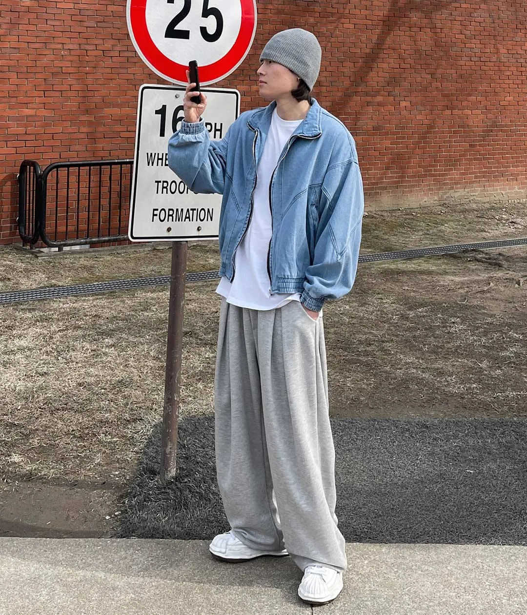 Light-blue denim jacket over a white T-shirt with wide gray sweatpants